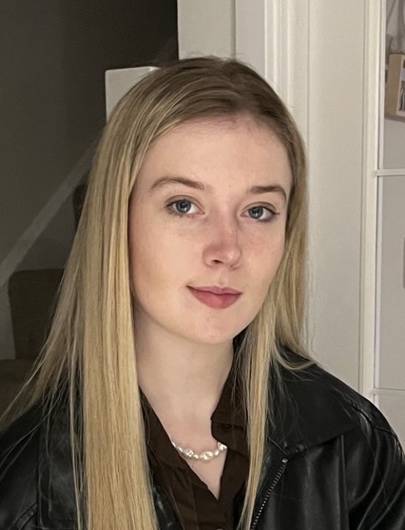 Headshot of Charlotte Phillips, young woman with long straight blond hair looking into the camera