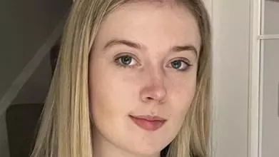 Headshot of Charlotte Phillips, young woman with long straight blond hair looking into the camera
